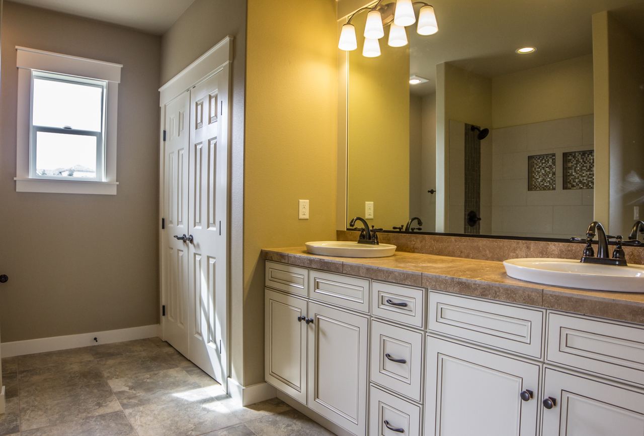 Bathroom with a white double vanity and two sinks